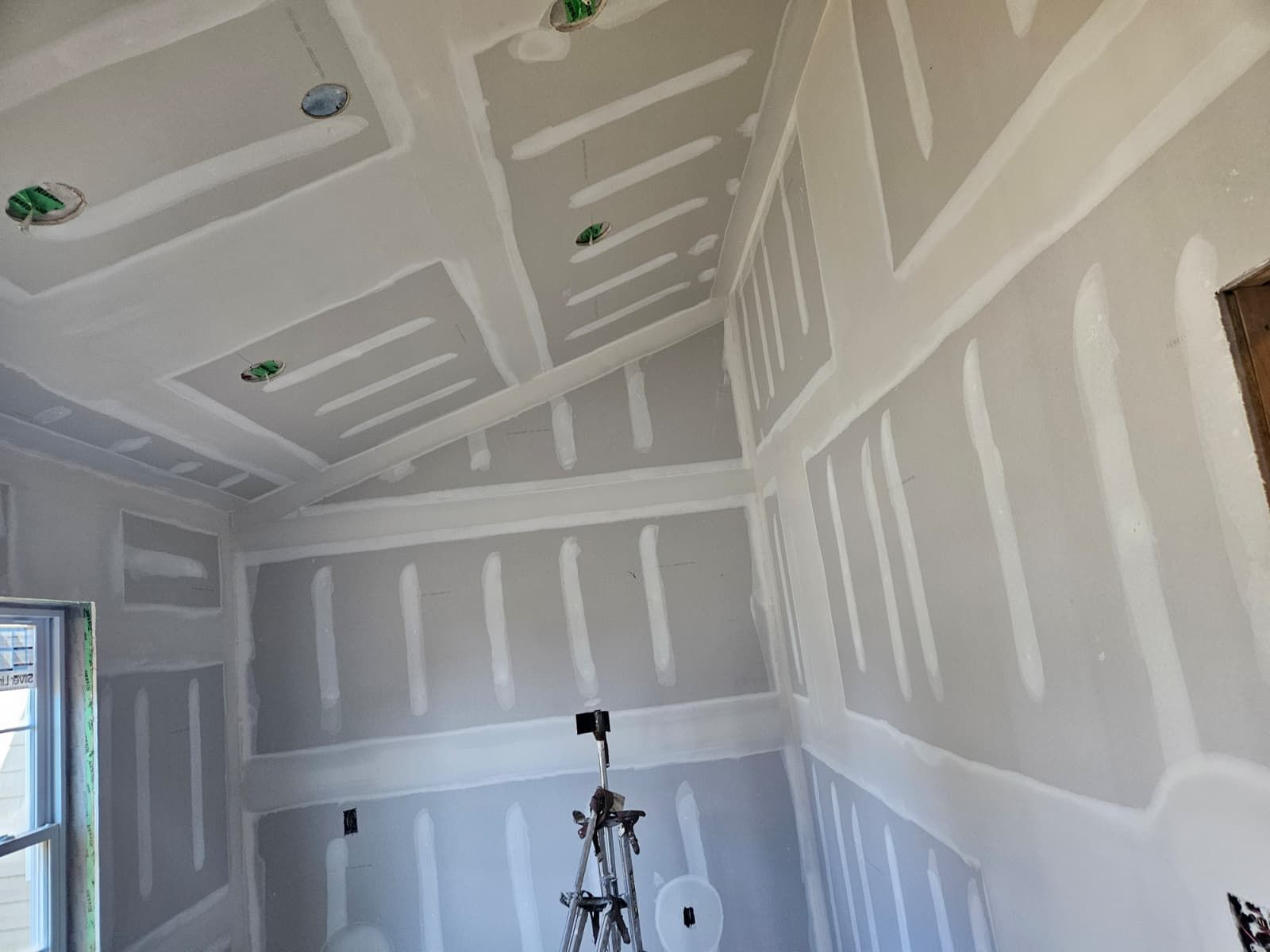 Angled ceiling and walls finished in a small room