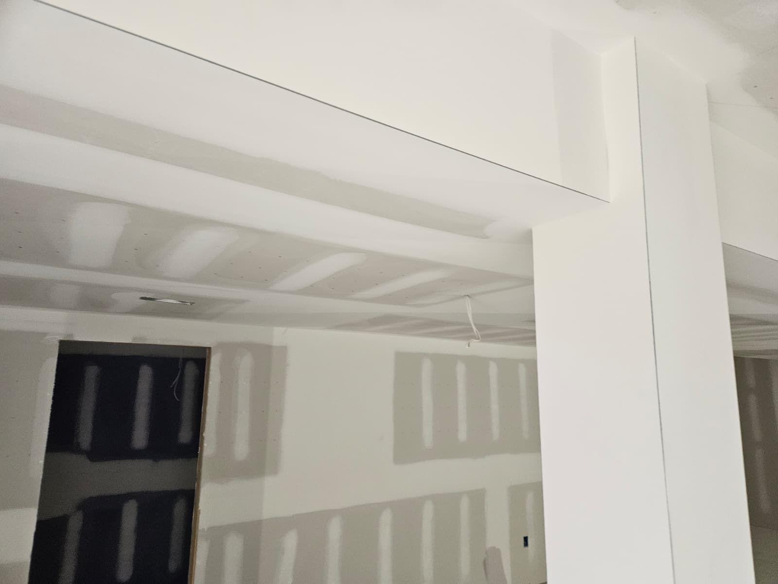 Soffit and door opening wrapped in drywall