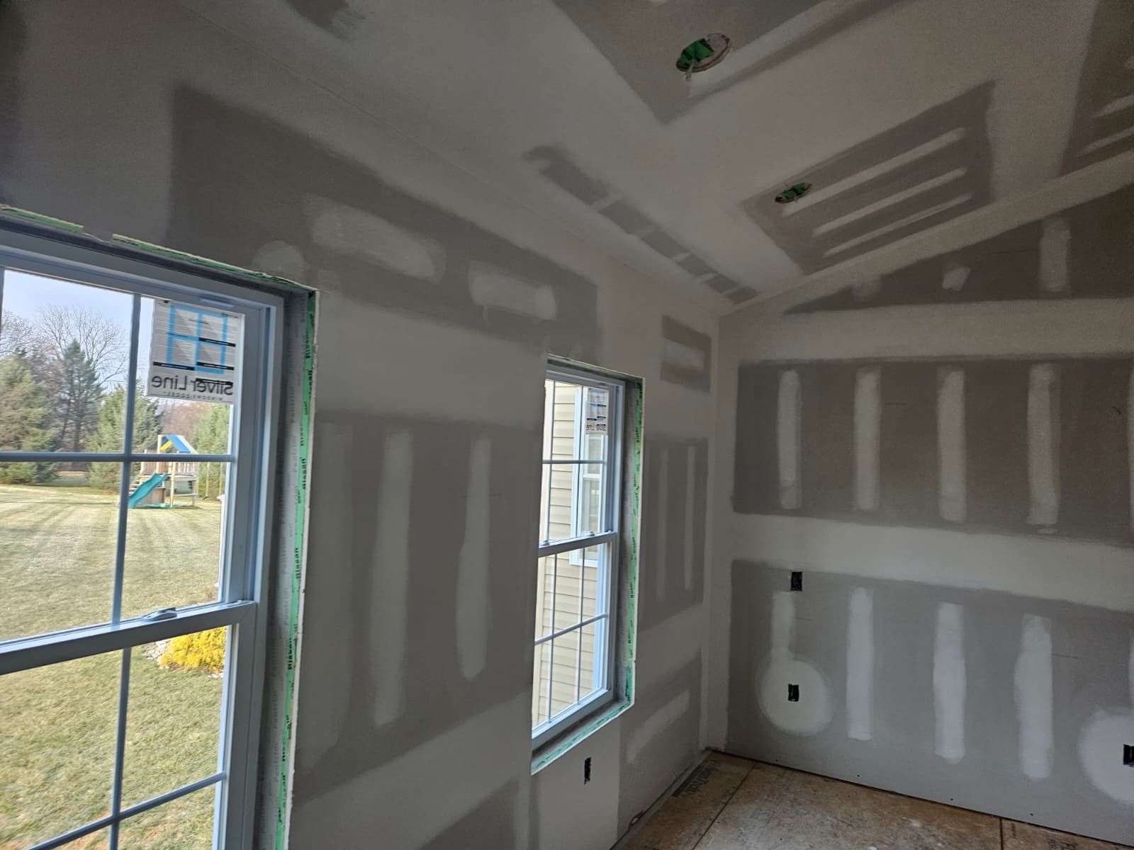 New home room drywalled around the windows