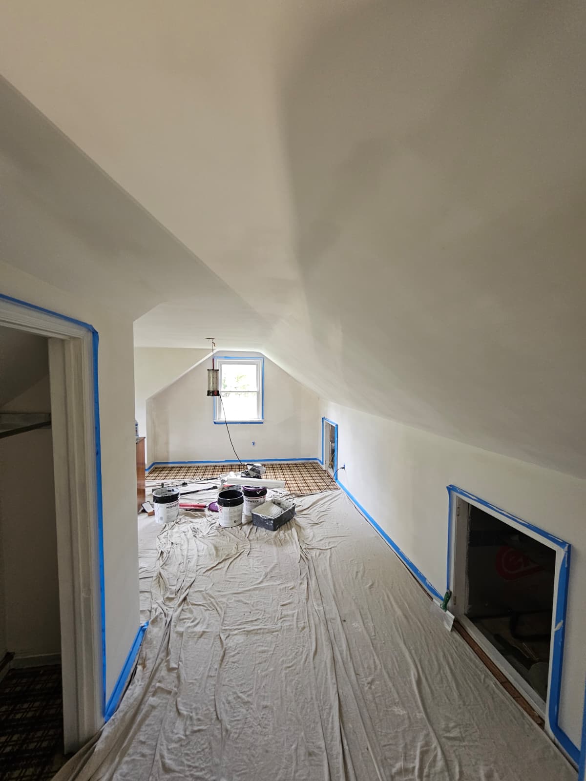 Walls and floors covered in plastic before scraping the ceiling