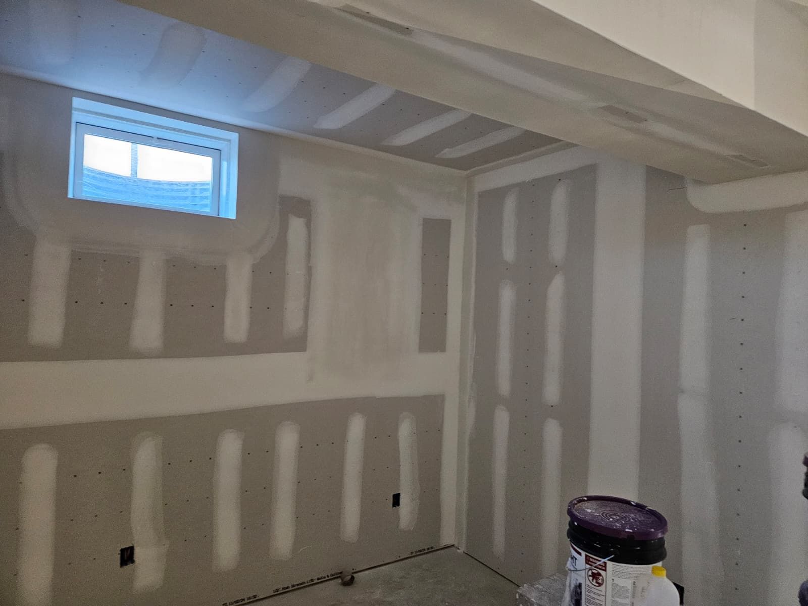Basement window wall rebuilt with new drywall